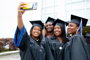 DU students taking selfie at commencement