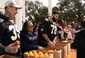 MLK Day of Service - New Orleans Saints with Dr Ford passing out food