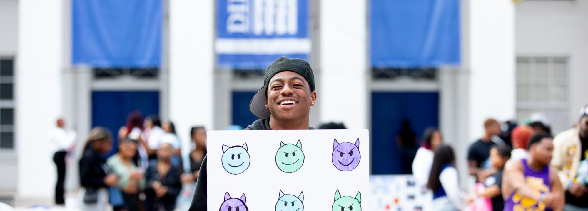 DU Student at orientation holding sign