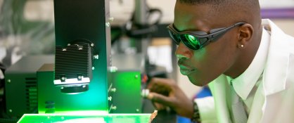 Dillard University Academics - student in physics class with microscope